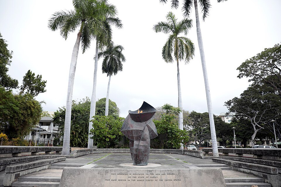 The eternal flame memorial between the palms of the Capitol grounds
