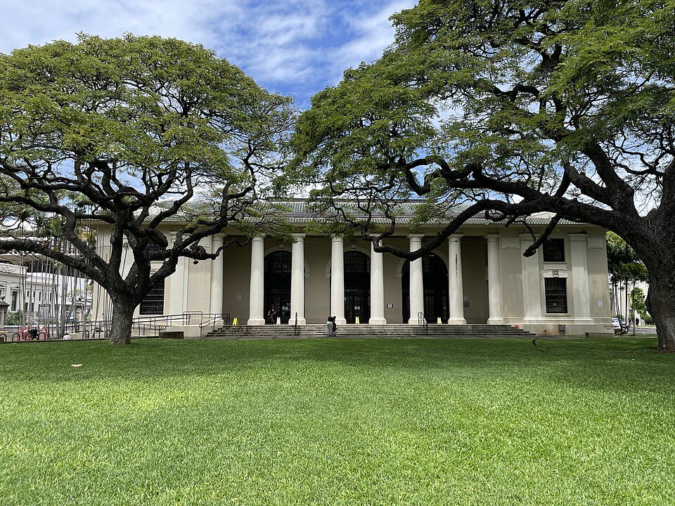 The Hawaiʻi State Library's colonnade under two monkeypod trees