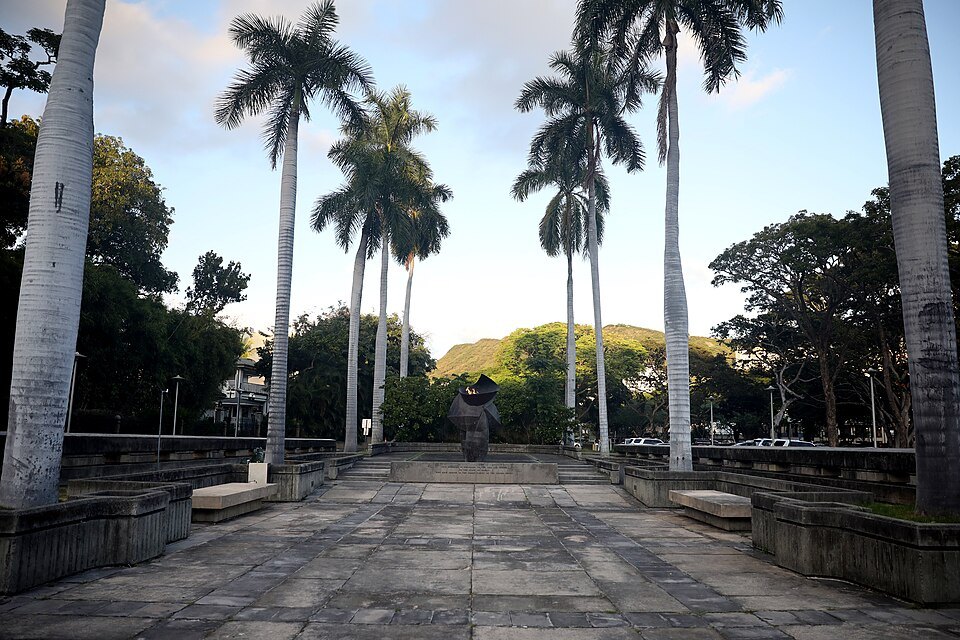 The flagstone approach to the eternal flame, royal palms either side