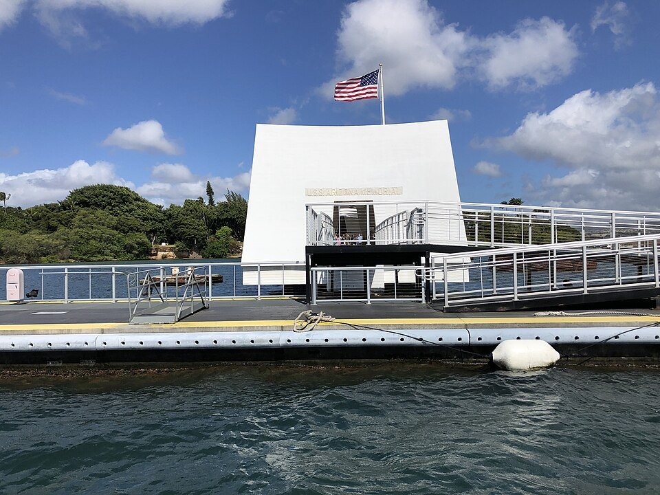 The white span of the USS Arizona Memorial over the sunken ship