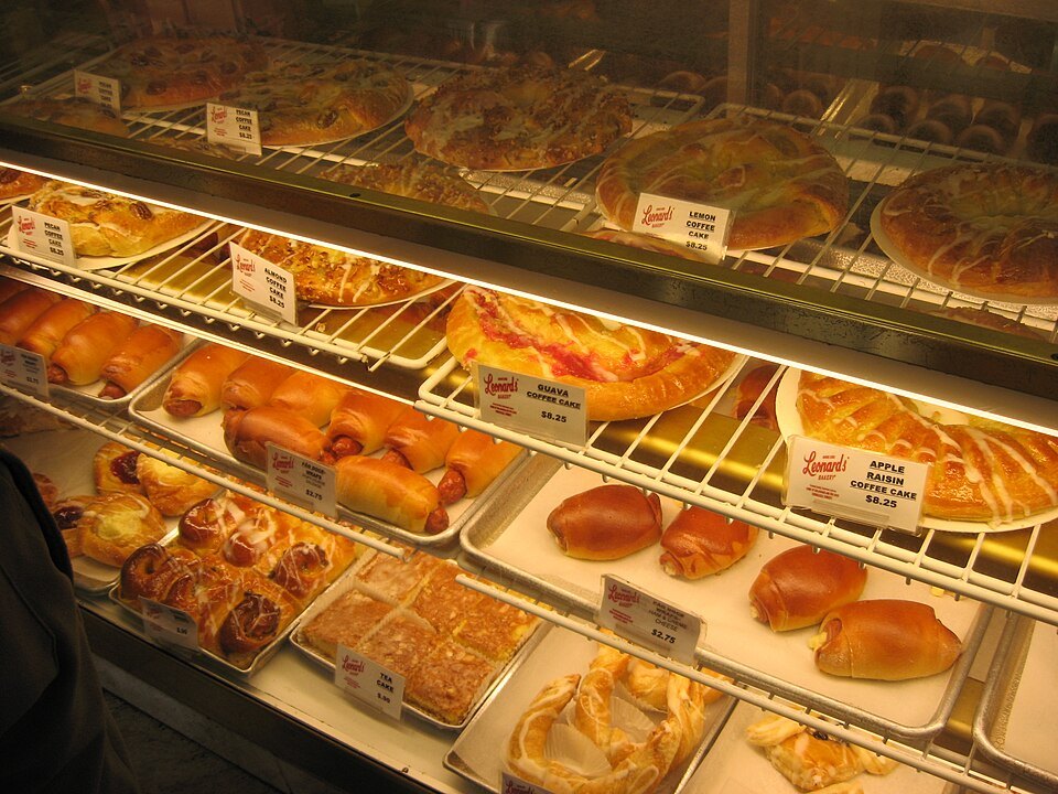 Malasadas and pastries in the case at Leonard's Bakery