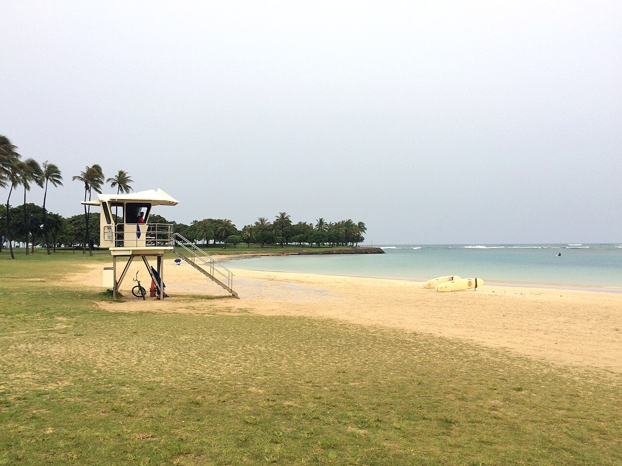 An empty beach and a lifeguard tower as a storm passed far offshore