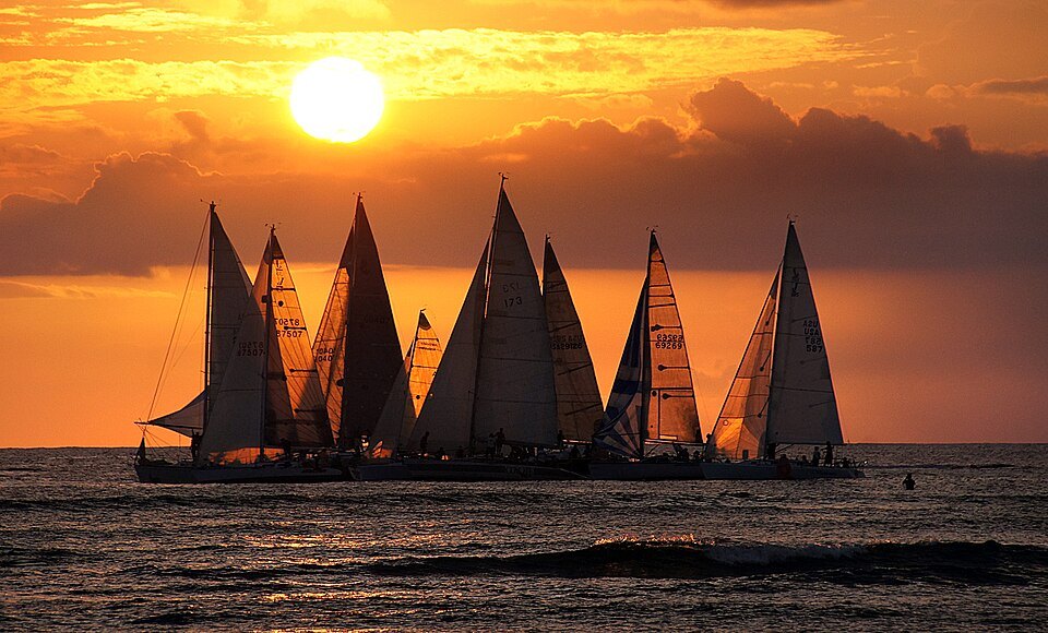 Sailboats heading out at sunset off Waikīkī