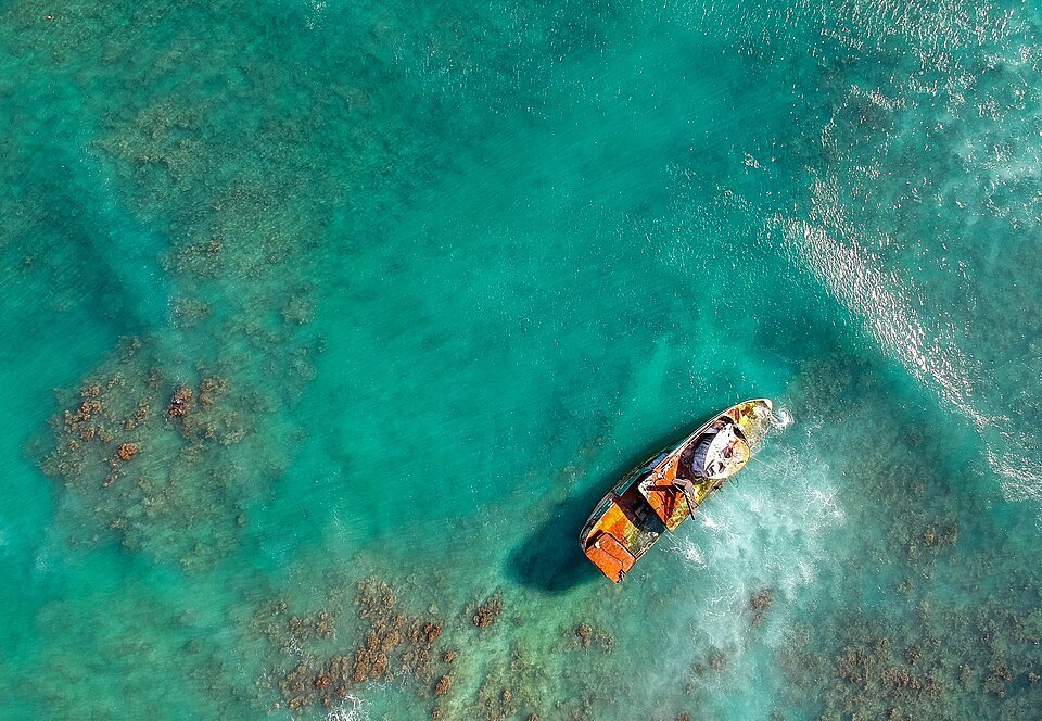 A small wreck on a shallow reef, seen from above