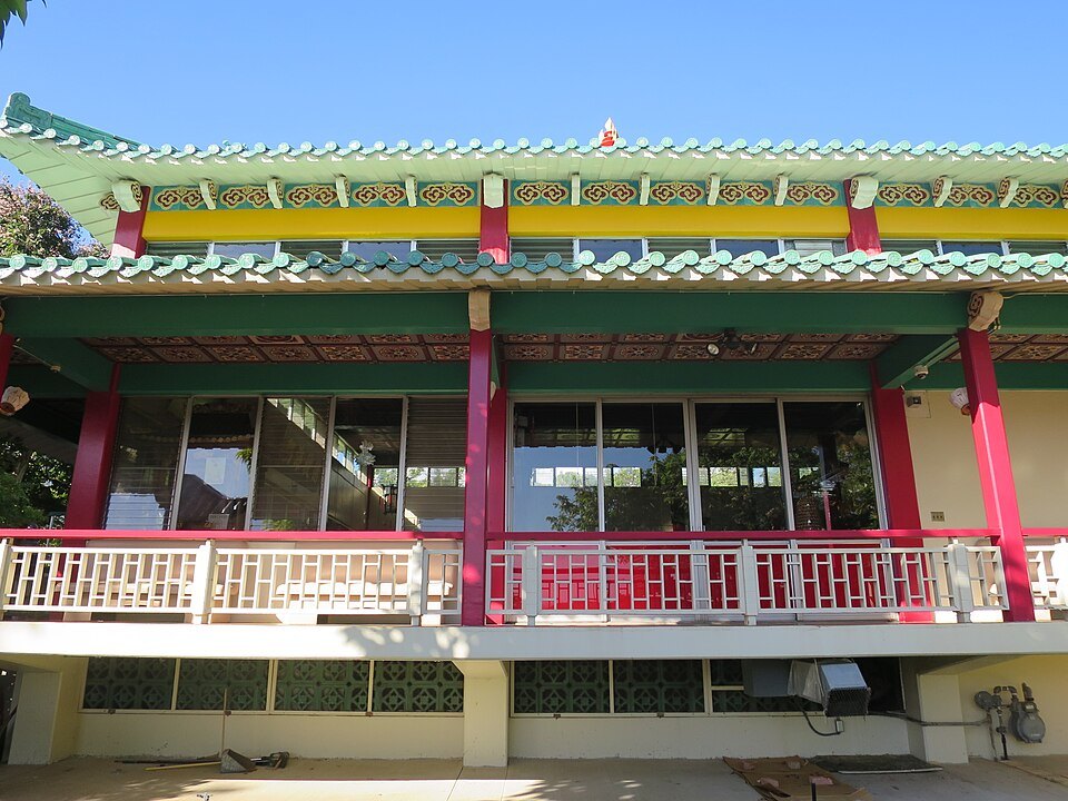 Kuan Yin Temple beside the garden, its roof edged in green tile