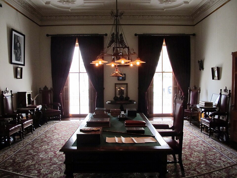 King Kalākaua's library in ʻIolani Palace, with its long table and carved chairs