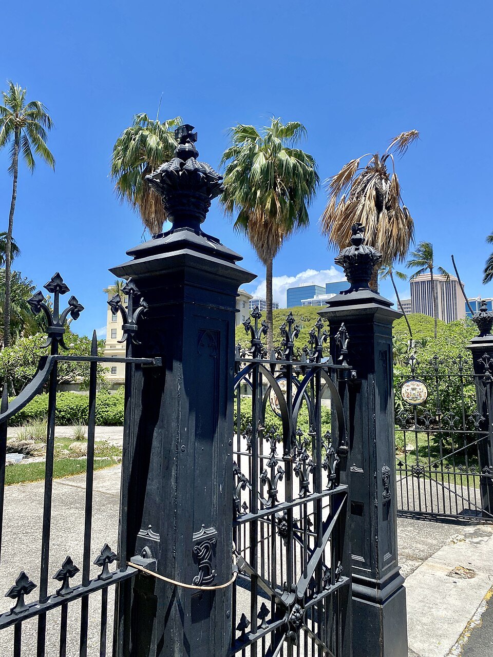 An iron gate of the churchyard, capped with lamps