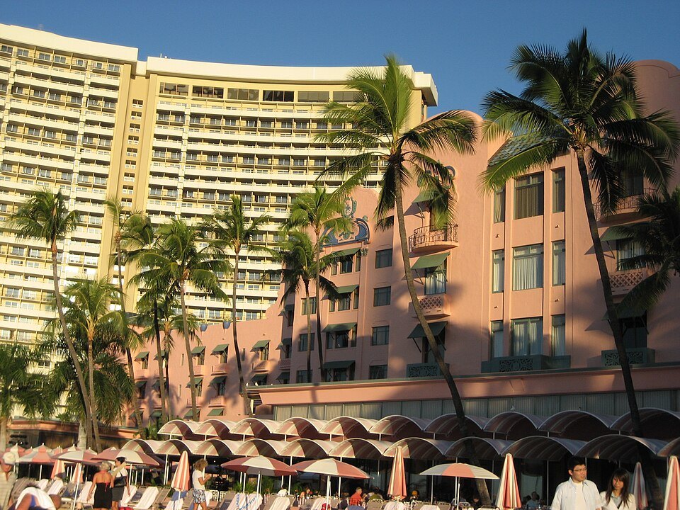 Beach umbrellas below the pink wing of the Royal Hawaiian