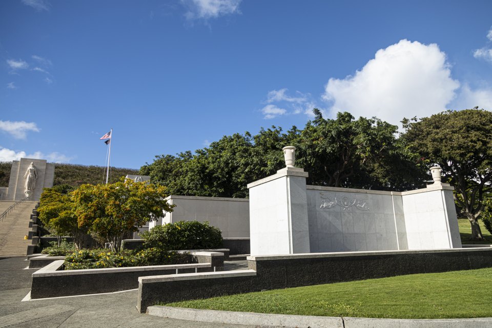 The memorial's walls and the flag above them