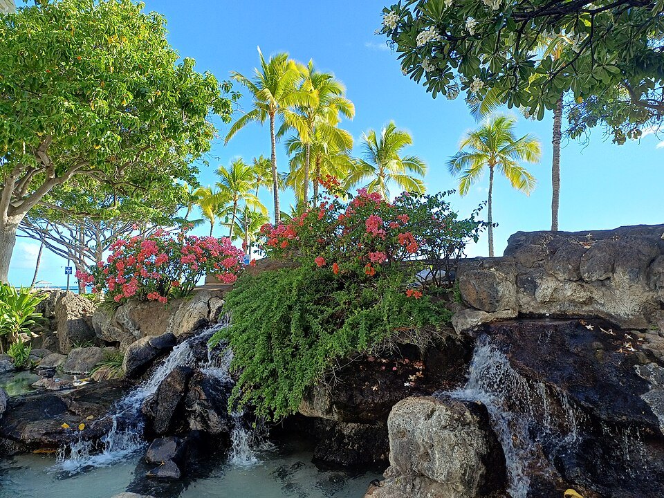 A waterfall cascade in the garden at Kūhiō Beach Park