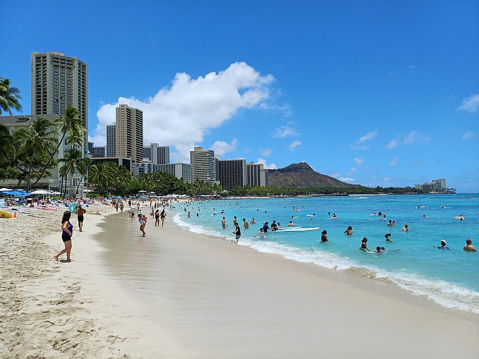 Swimmers in the clear shallows of Waikīkī Beach